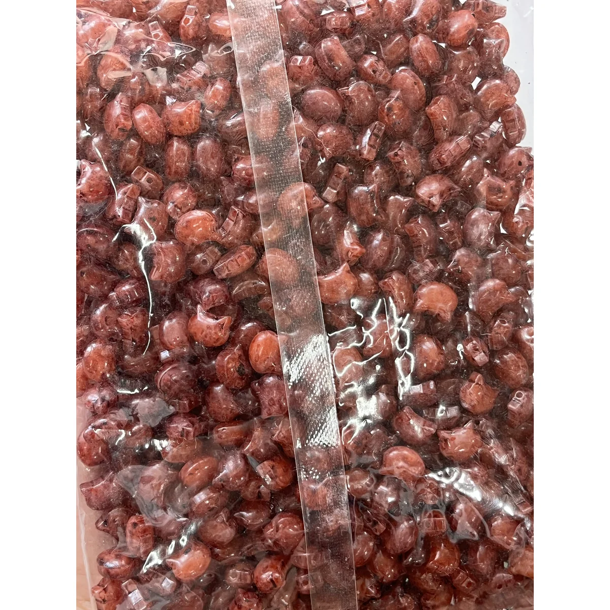 Burgundy Picasso-style glass cat-head beads in the photographed sales bag – 10 × 8 mm