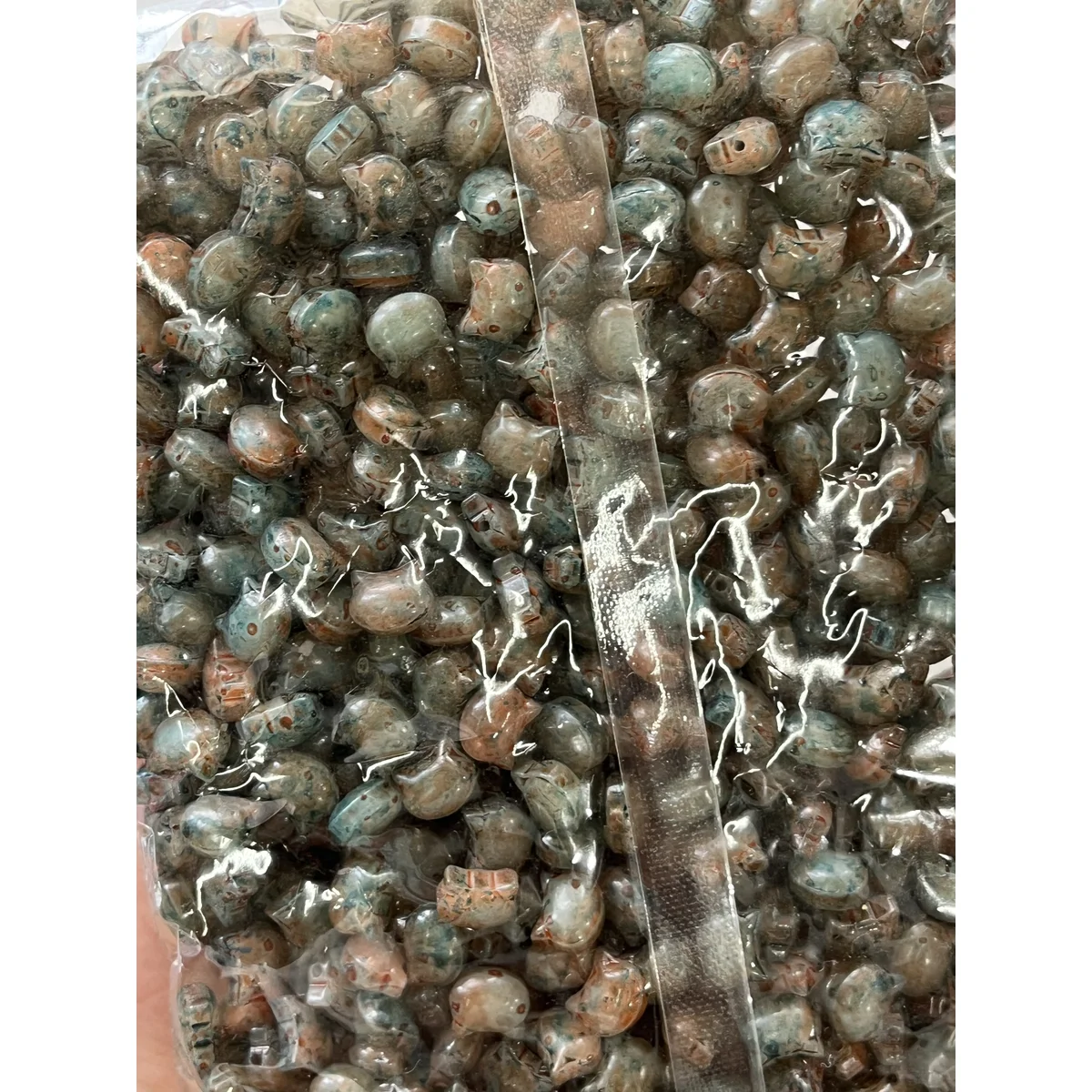 Gray Picasso-style glass cat-head beads in the photographed sales bag – 10 × 8 mm