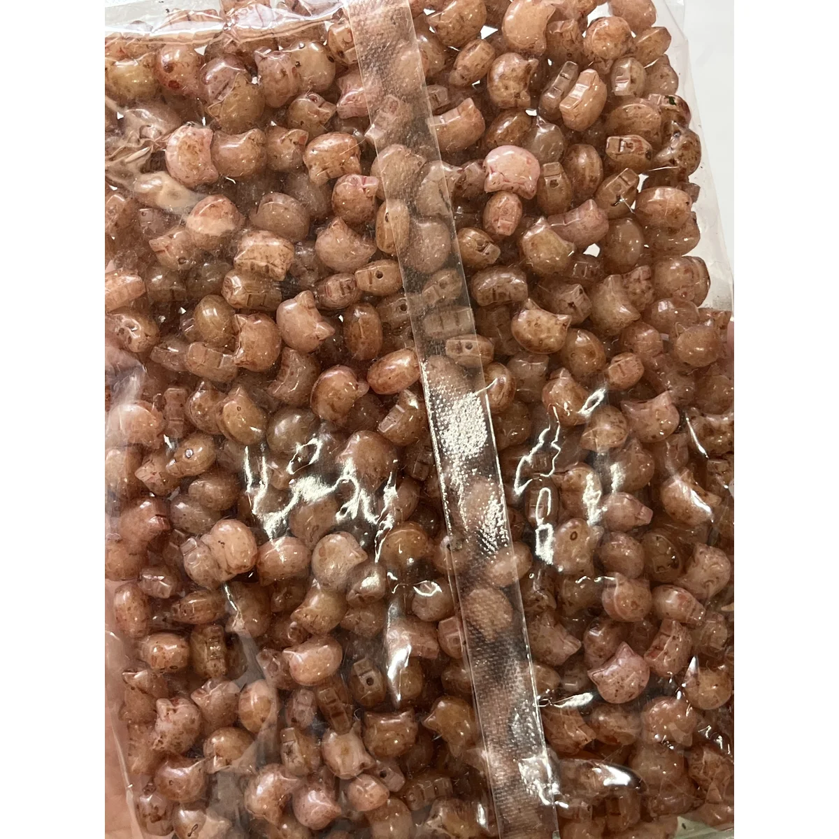 Brown Picasso-style glass cat-head beads in the photographed sales bag – 10 × 8 mm