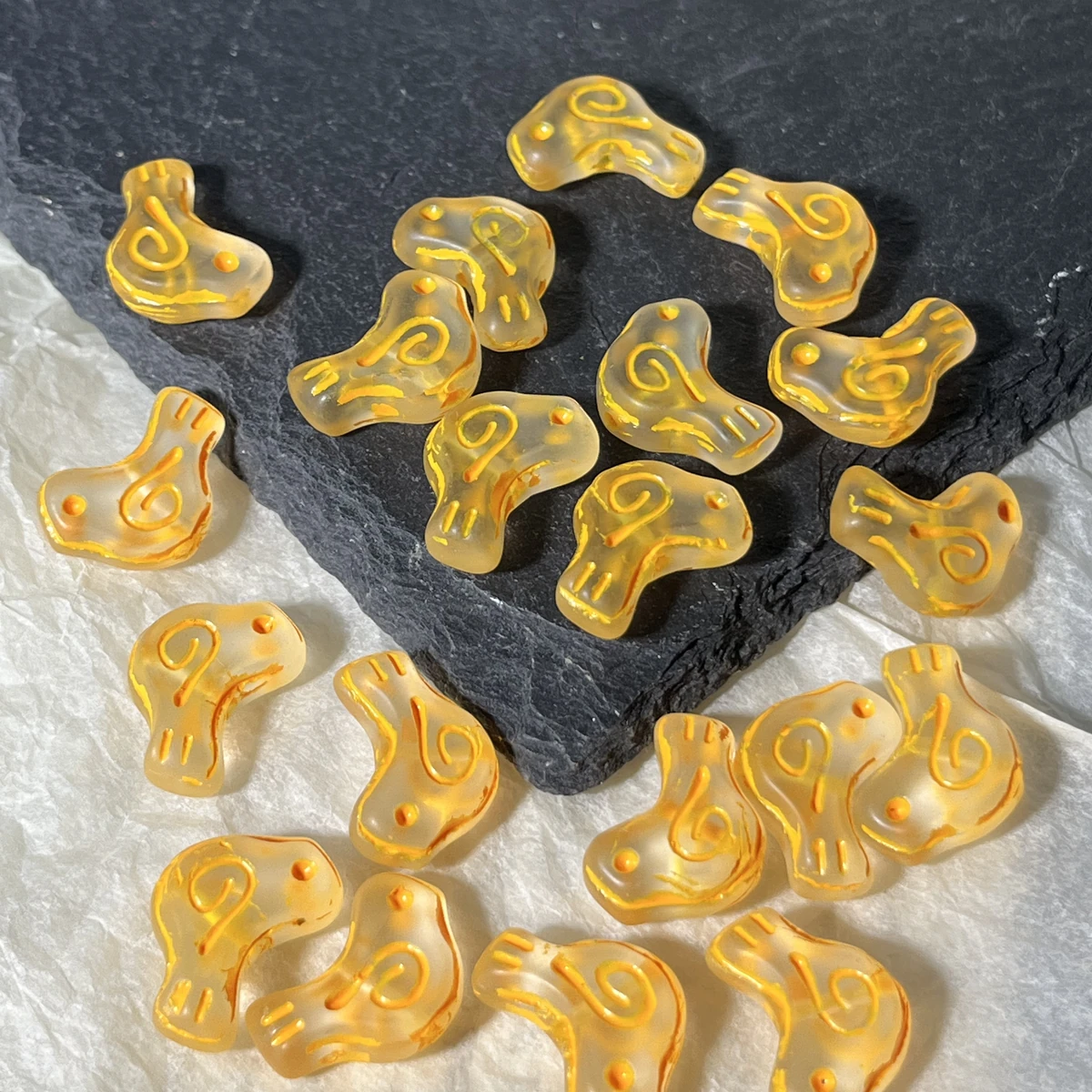 Yellow translucent glass bird beads with colored spiral details