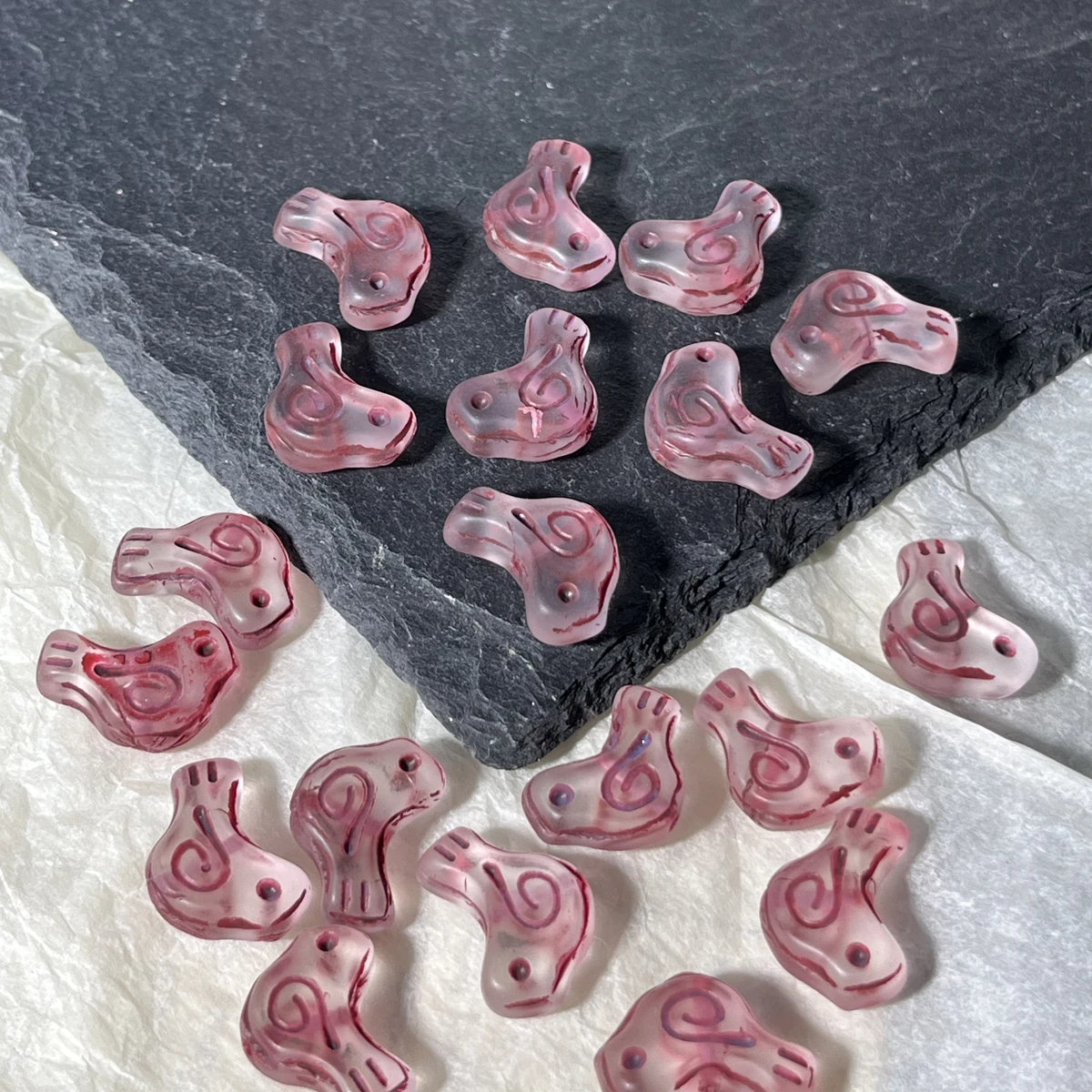 Pink translucent glass bird beads with colored spiral details