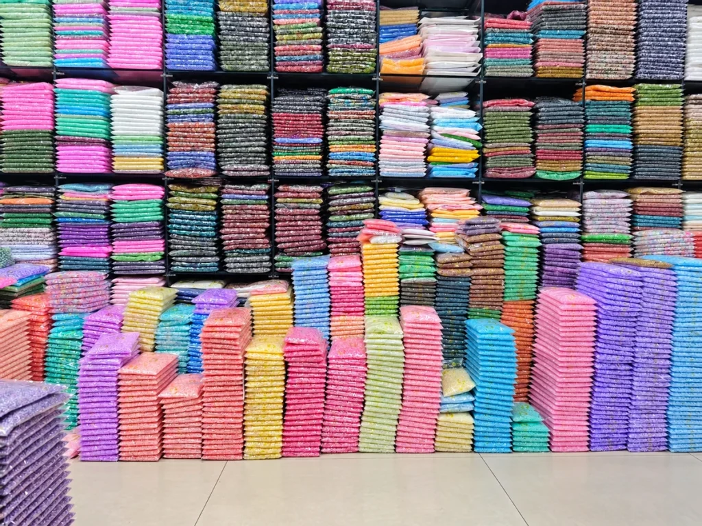 Shop shelves and stacked bags of colorful beads for wholesale selection